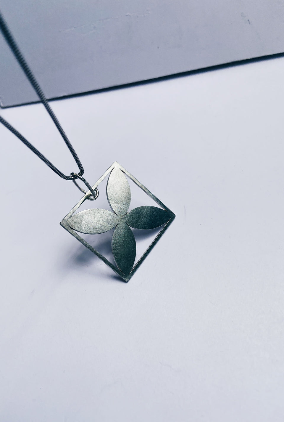 Square framed four-leafed pendant