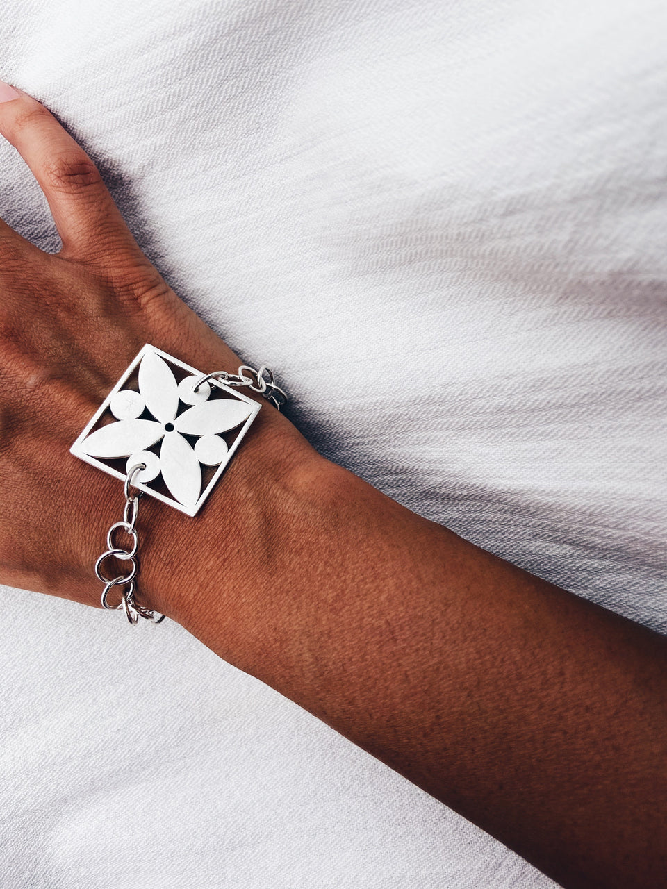 Square framed flower with circles bracelet