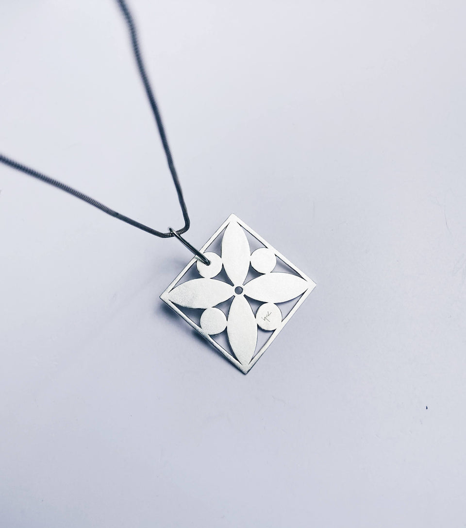 Square framed flower with circles pendant