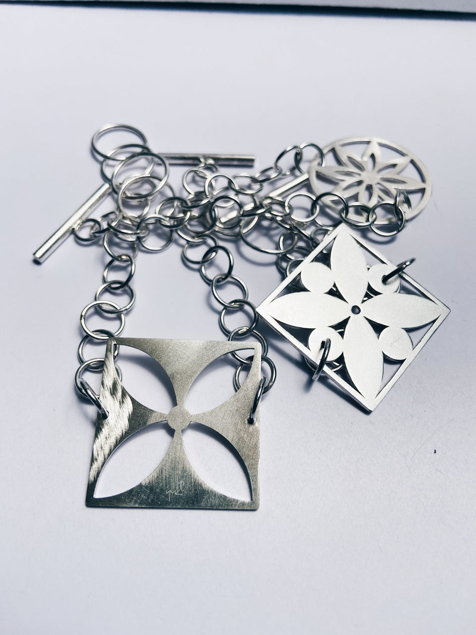 Square framed flower with circles bracelet