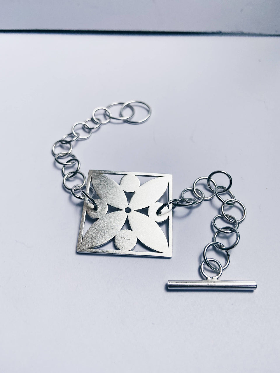 Square framed flower with circles bracelet